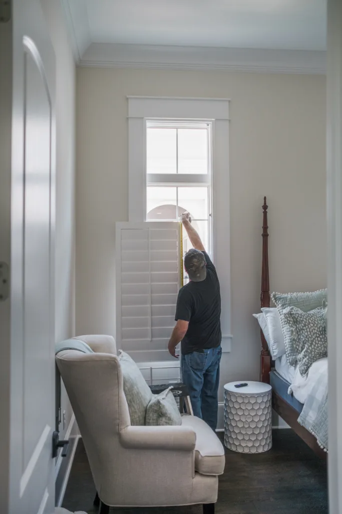 Our installer, Bill, making sure our real wood indoor shutter is the perfect custom fit.